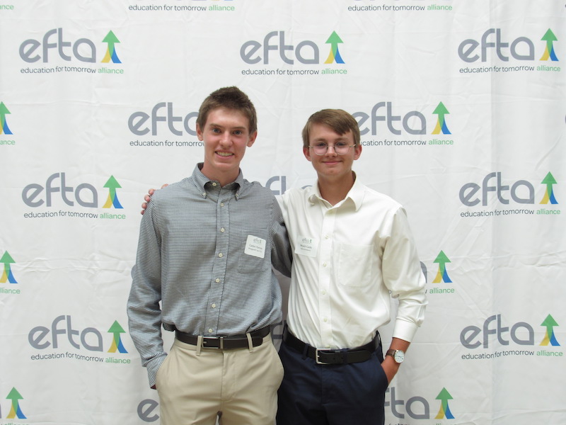 Caden Hanson, intern with Weygandt Law, and Wyatt Cade, intern with VLK Architects enjoy the luncheon